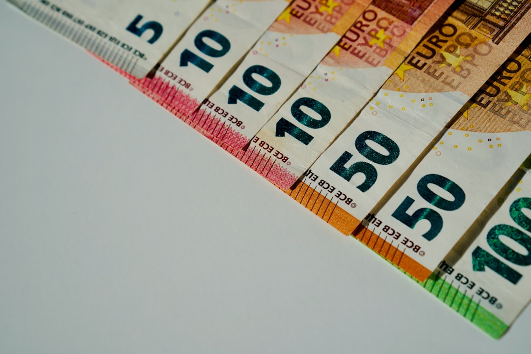a row of ten hundred dollar bills sitting on top of a table